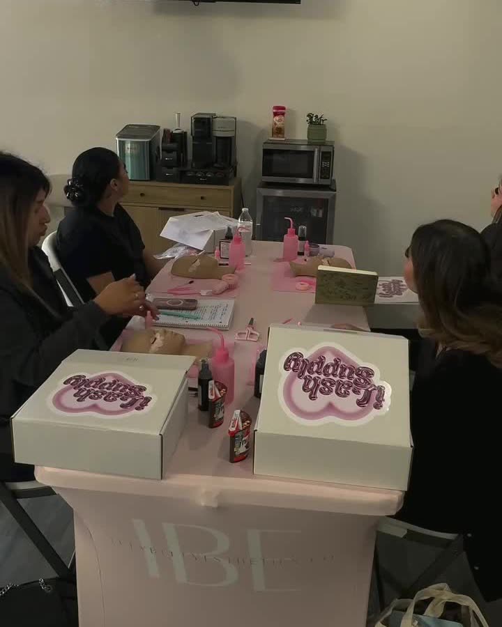 Students at the training table during a course, with the lesson on screen