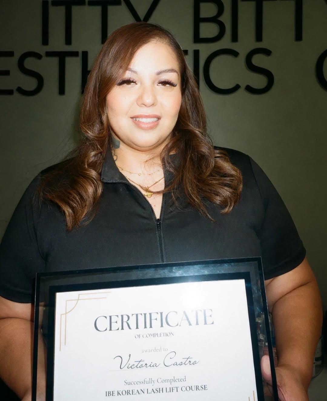 Graduate holding her IBE Korean Lash Lift Course certificate